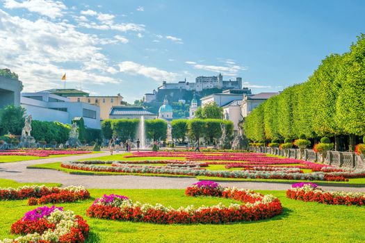 Beautiful view of famous Mirabell Gardens with the old historic Fortress Hohensalzburg in the background, Salzburg in Austria