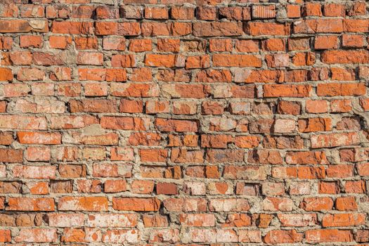 heavily weathered brick wall texture and background with deep water erosion.