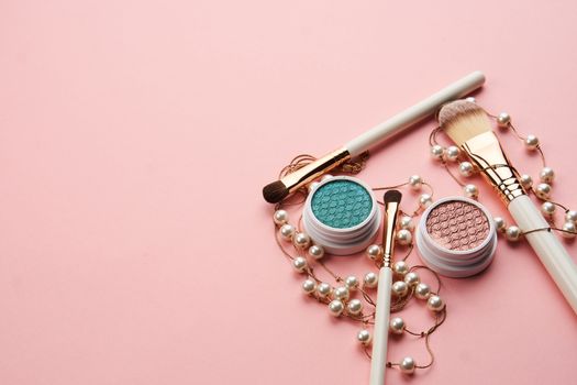 eyeshadow accessories beads makeup brushes collection professional cosmetics on pink background. High quality photo