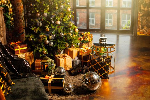 Christmas tree decorated with gold balls. Under the Christmas tree a large number of Christmas gifts. Christmas holiday concept. A huge number of gift boxes under Holiday background