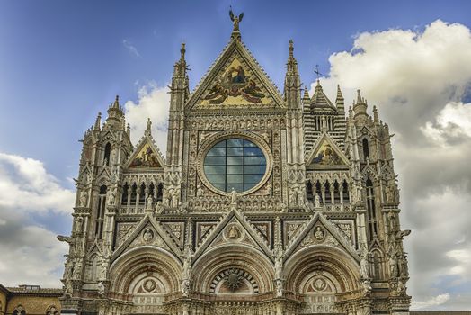 View of the facade of the gothic Cathedral of Siena, Tuscany, Italy. Completed in 1348, the church is dedicated to the Assumption of Mary and it is one of the most visited sightseeing of Siena