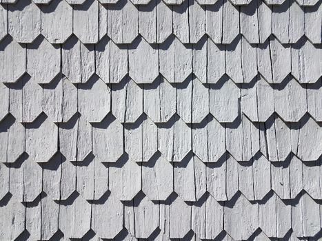pattern of grey wood shingles on side of house or home