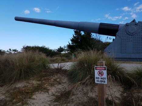 large metal artillery gun or weapon and danger do not climb sign in Lewes, Delaware