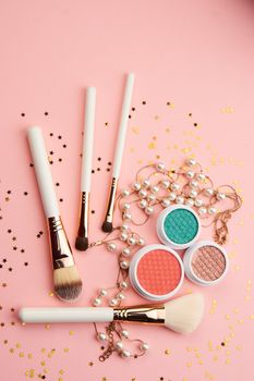 eyeshadow accessories beads makeup brushes collection professional cosmetics on pink background. High quality photo