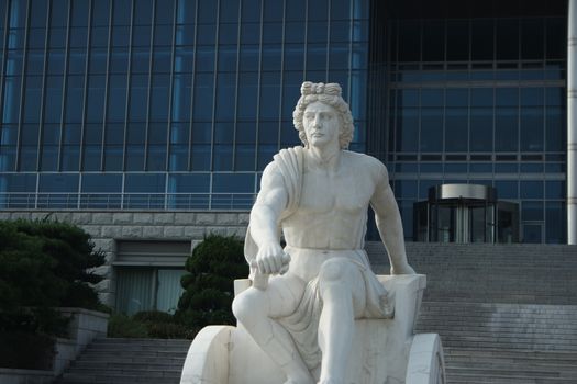 White marble stone statue of sitting Poseidon or Neptune