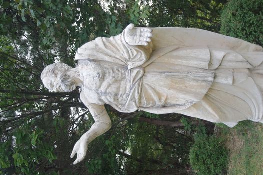 The ancient marble portrait of man with beard placed in a public park