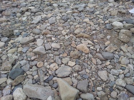 Transparent water surface with copy space for background and texture. Transparent water texture with view of stones under water.