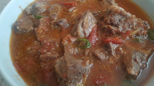 A close up view of stewed chicken meat cubes with spices on it, a traditional home made delicious chicken meat dish