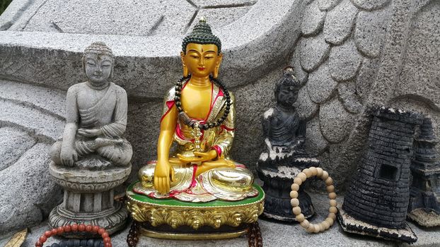 Closeup view of statues of religious monks. Buddha mini statue with beautiful background