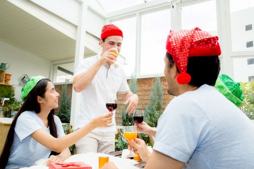 Asian group people drinking at party outdoor. Group of friends cocktails in hand with glasses.