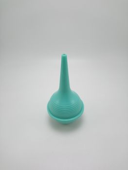 Green baby nasal aspirator or snot sucker use to suck out mucus booger