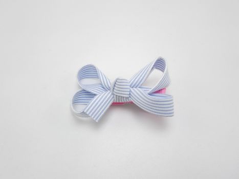 Baby girl ribbon hair pin use to tie the hair of a person