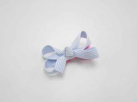 Baby girl ribbon hair pin use to tie the hair of a person