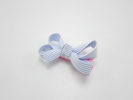 Baby girl ribbon hair pin use to tie the hair of a person