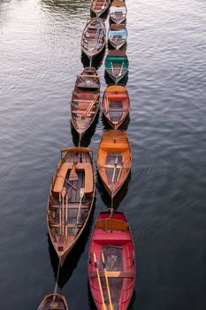 Wooden boats for hire moored on the River Thames, London, England
