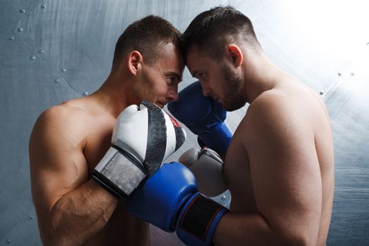 Two men boxers fighting muay thai boxing.