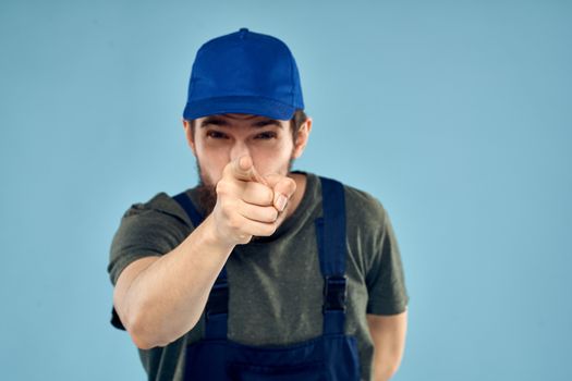 man in work uniform uniform professional work lifestyle delivery service blue background. High quality photo