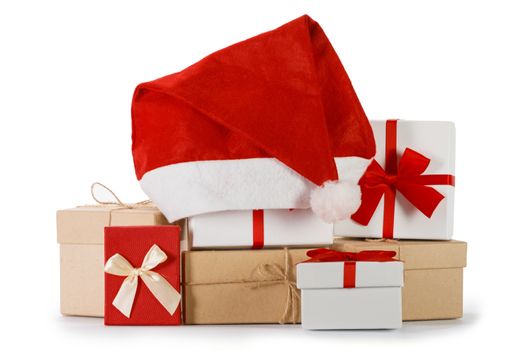 Heap of many Christmas gifts and santa hat isolated on white background