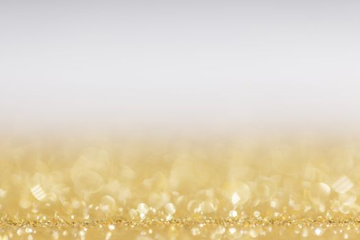 Abstract golden glitter background of shiny lights bokeh Christmas New year celebration luxury party