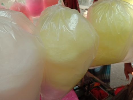 tasty and healthy pink and white and yellow colored cotton candy