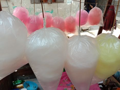 tasty and healthy pink and white and yellow colored cotton candy