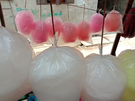 tasty and healthy pink and white and yellow colored cotton candy