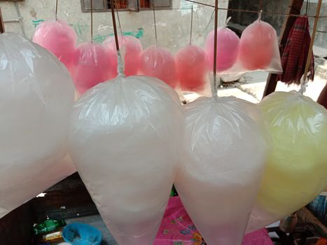 tasty and healthy pink and white and yellow colored cotton candy