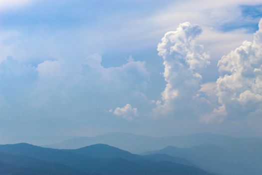 Mountains and hills in the distance. Blue silhouette of a mountain in the distance, with clouds in the blue sky. Bosnia and Herzegovina.