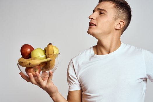 Man with fresh fruit in a cup health lifestyle healthy nutrition vitamins. High quality photo