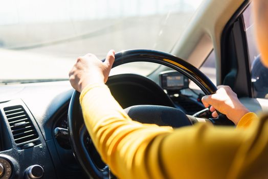 Asian woman while driving the car in the morning during going to work on highway road, Transportation and vehicle concept