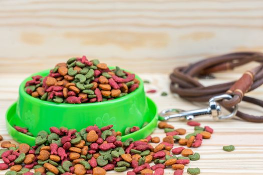 Pet food with leashes on wooden background