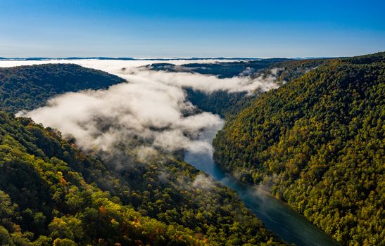 Aerial drone image of the Cheat River flowing through narrow wooded gorge in the autumn towards Cheat Lake near Morgantown, WV