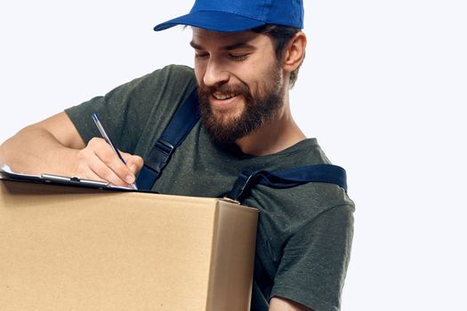 Working male courier with box in hand documents delivery service light background. High quality photo