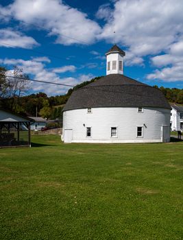 Well preserved white wooden round barn with cupola in Mannington, West Virginia