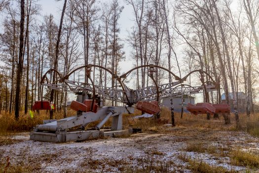 Old electric carousel in a winter park in Russia.