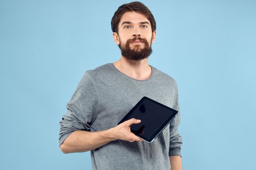 Man with tablet in hands technology lifestyle wireless device blue background. High quality photo