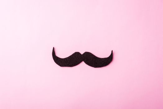 Black mustache paper, studio shot isolated on pink background, Prostate cancer awareness month, Fathers day, minimal November moustache concept