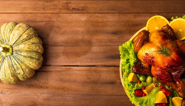 Thanksgiving roasted turkey or chicken and vegetables, Top view Christmas dinner feast food decoration traditional homemade on wooden table background, Happy thanksgiving day of holiday concept