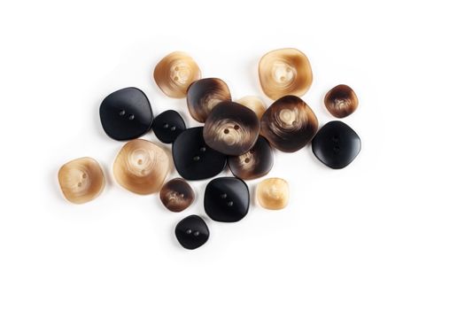 pile, allsorts of brown old gray, beige and brown buttons on a white background. image for sewing and tailor store. space for text