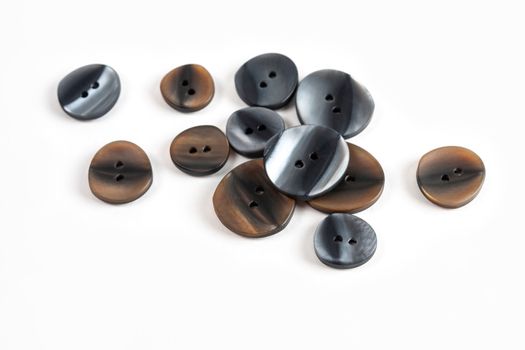 pile, allsorts of brown old gray, beige and brown buttons on a white background. image for sewing and tailor store. space for text