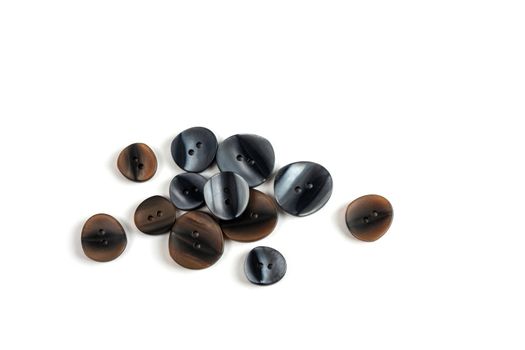pile, allsorts of brown old gray, beige and brown buttons on a white background. image for sewing and tailor store. space for text