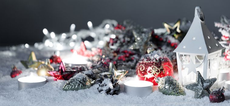 Christmas holidays card with gifts , balls and glowing lantern in snow