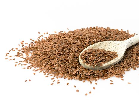 Flax seeds with wooden spoon. Close up of flax seeds isolated on white background.