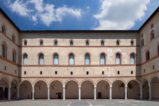 View from internal court to walls and arcades of ancient medieval fortress Rocchetta inside the Sforza castle. Milan, ITALY - July 7, 2020.