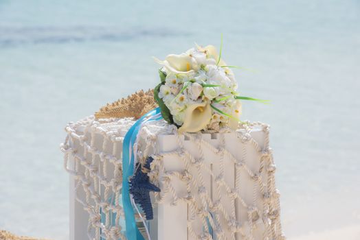 Closeup of wedding romantic decorations on tropical island sandy beach paradise with ocean in background