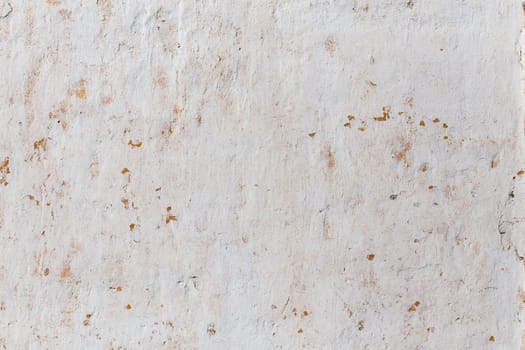 Shabby flat plaster wall with yellow streaks.