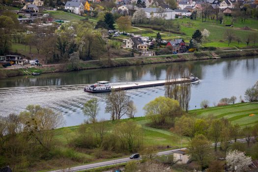 Cargo ship on river mosel. In the background the village wehlen 