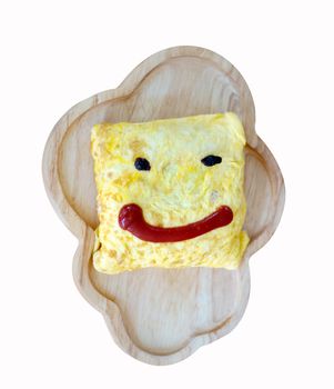 Omelette Wrapped with Pork and Stir-fried Sauce That painted a smiley face with a sauce Placed on a wooden plate