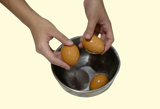 The boiled egg was being shelled  by the woman's hand.