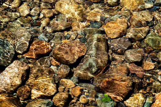 Clear water in the river and stone texture background
